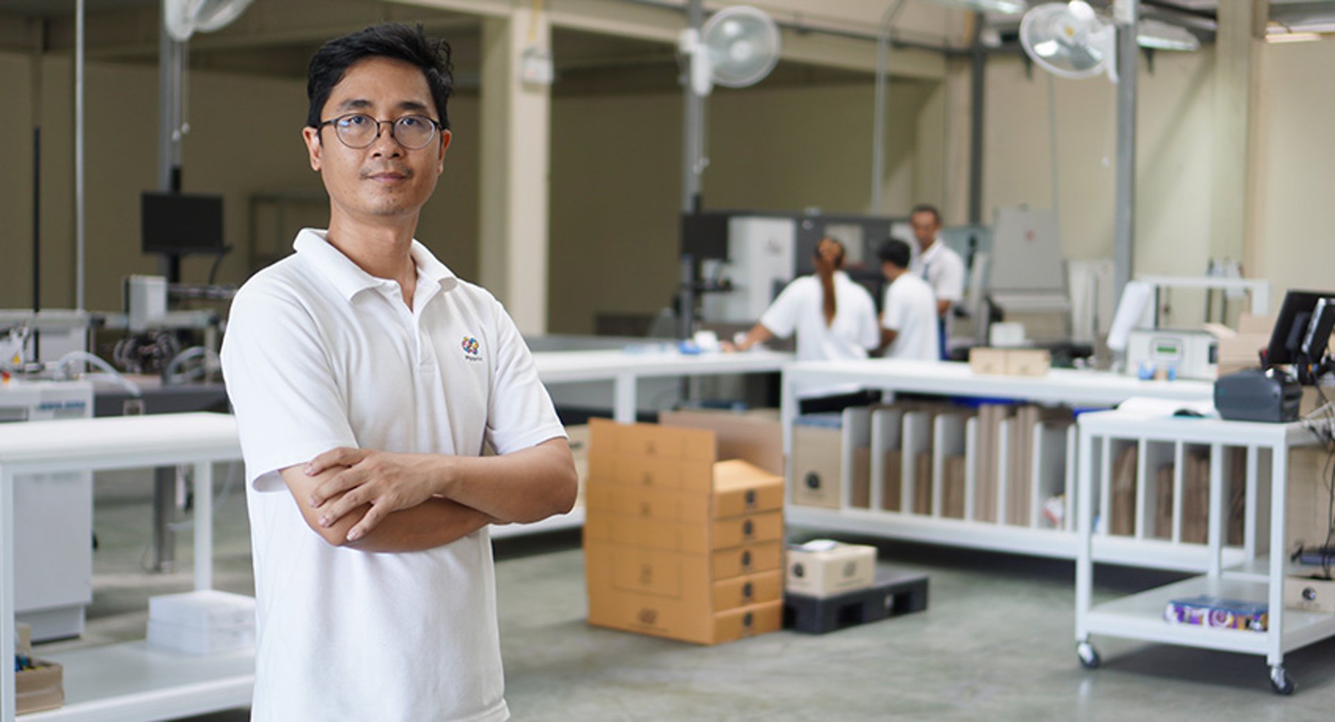 man standing in a white production lab